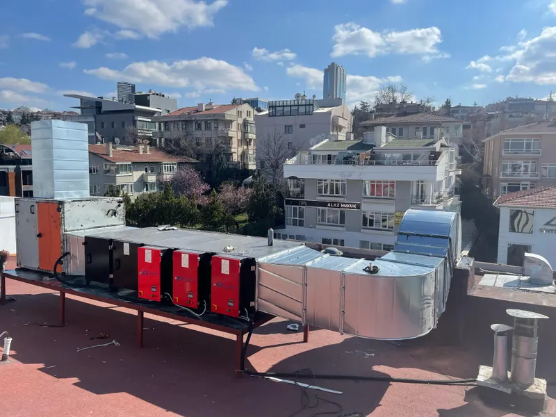 Şehir manzaralı çatıda üç filtre hücresi, hava santrali ve galvaniz kanal hattı
